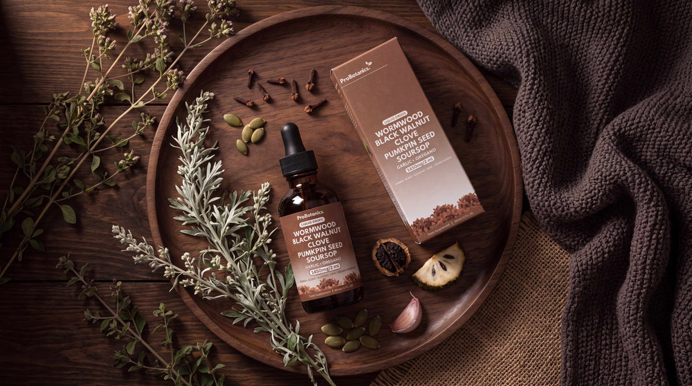 Wormwood, Black Walnut & Clove Drops — bottle and packaging on a clean surface, natural light